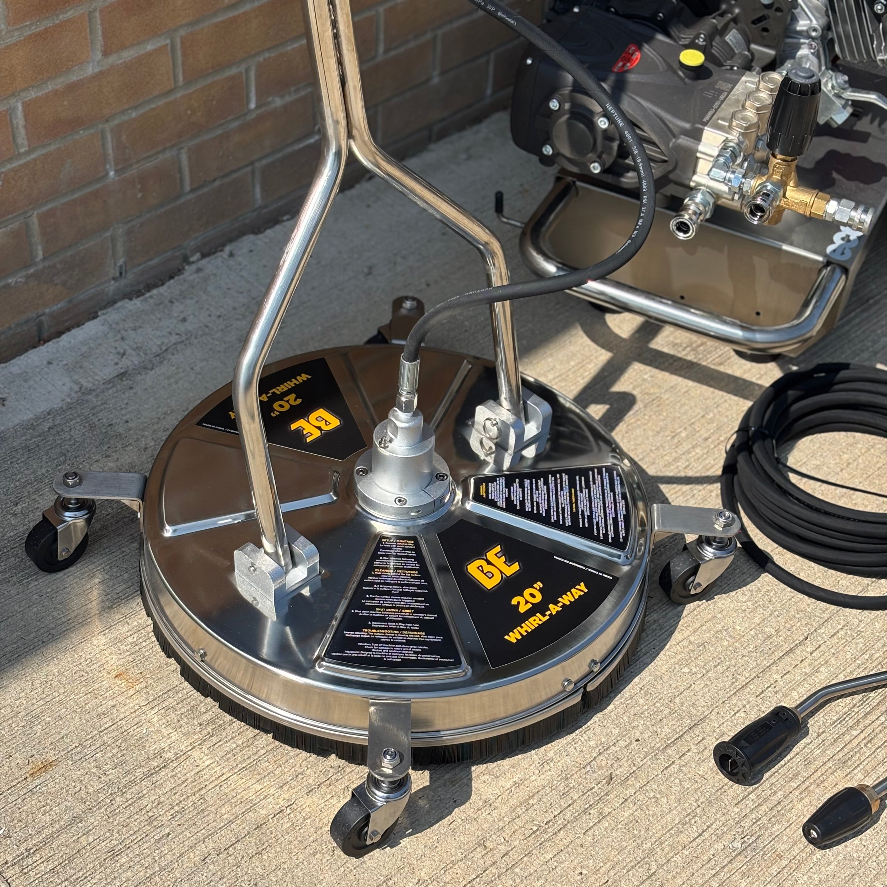 BE Whirlaway 20 inch stainless steel flat surface cleaner on a commercial driveway