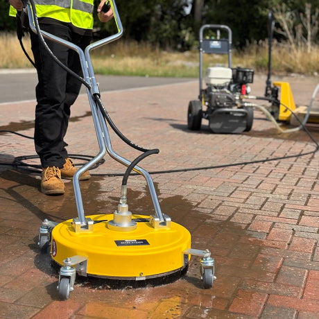 Flat surface cleaner and a honda pressure washer pressure washing a patio
