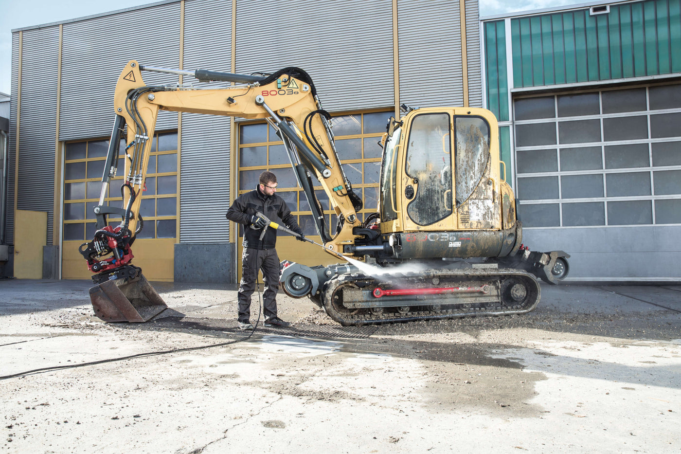 pressure washing an industrial digger